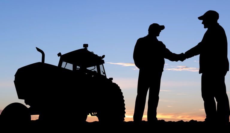 Silhouette of farmer shaking hands with manager